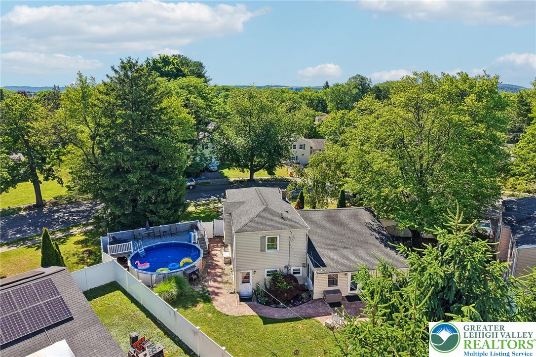 2649 Nottingham Road Bethlehem, PA 18017 - Photo 40 of 49 An aerial perspective reveals a private yard with a pool and brick patio, all framed by mature trees.