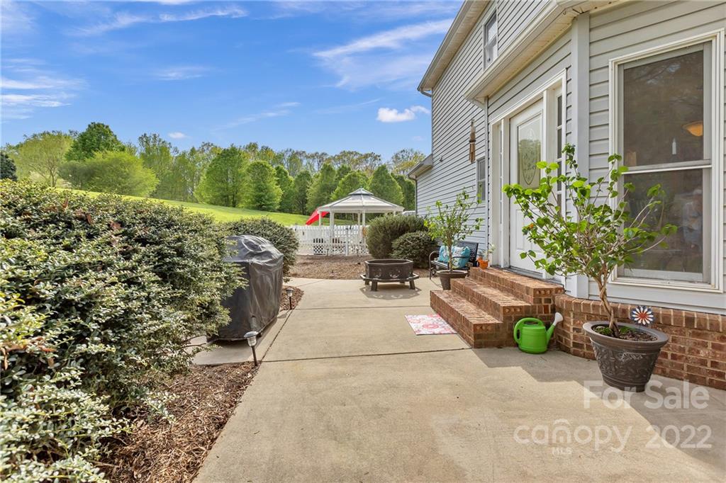331 Polk Ford Road Stanfield, NC 28163 - Photo 11 of 47 a view of a patio with couches table and chairs and potted plants