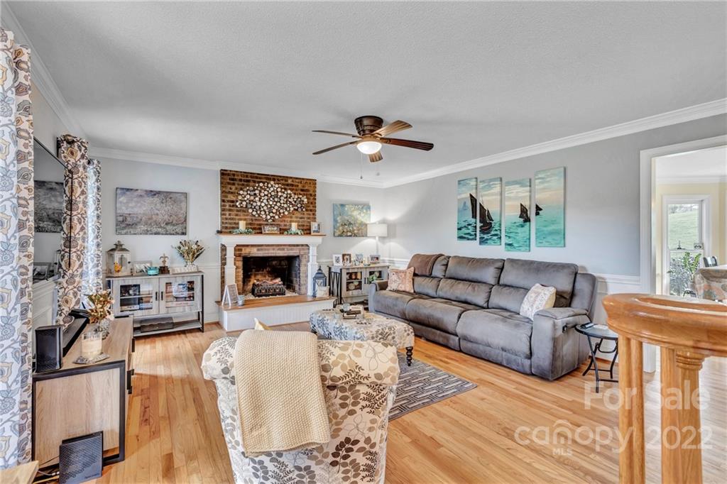 331 Polk Ford Road Stanfield, NC 28163 - Photo 13 of 47 a living room with furniture a fireplace and a large window
