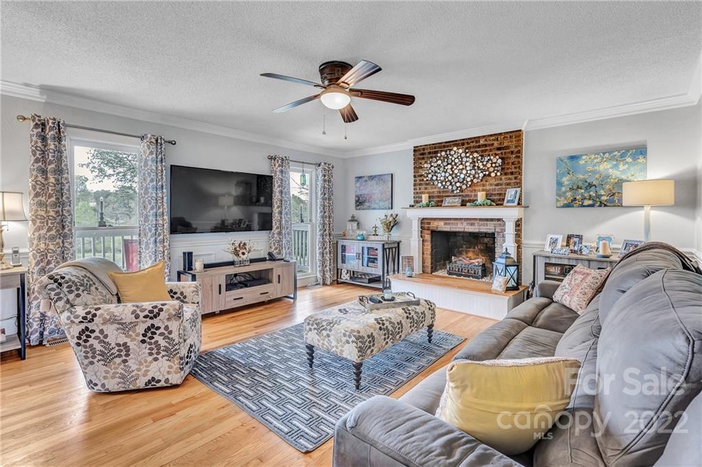 331 Polk Ford Road Stanfield, NC 28163 - Photo 14 of 47 a living room with furniture a flat screen tv and a fireplace