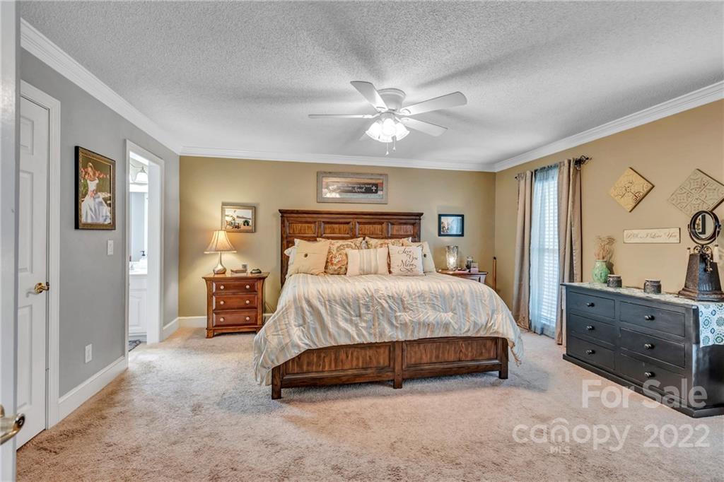 331 Polk Ford Road Stanfield, NC 28163 - Photo 17 of 47 a spacious bedroom with a bed and cabinet
