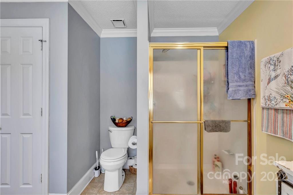331 Polk Ford Road Stanfield, NC 28163 - Photo 21 of 47 a bathroom with a granite countertop shower and a toilet