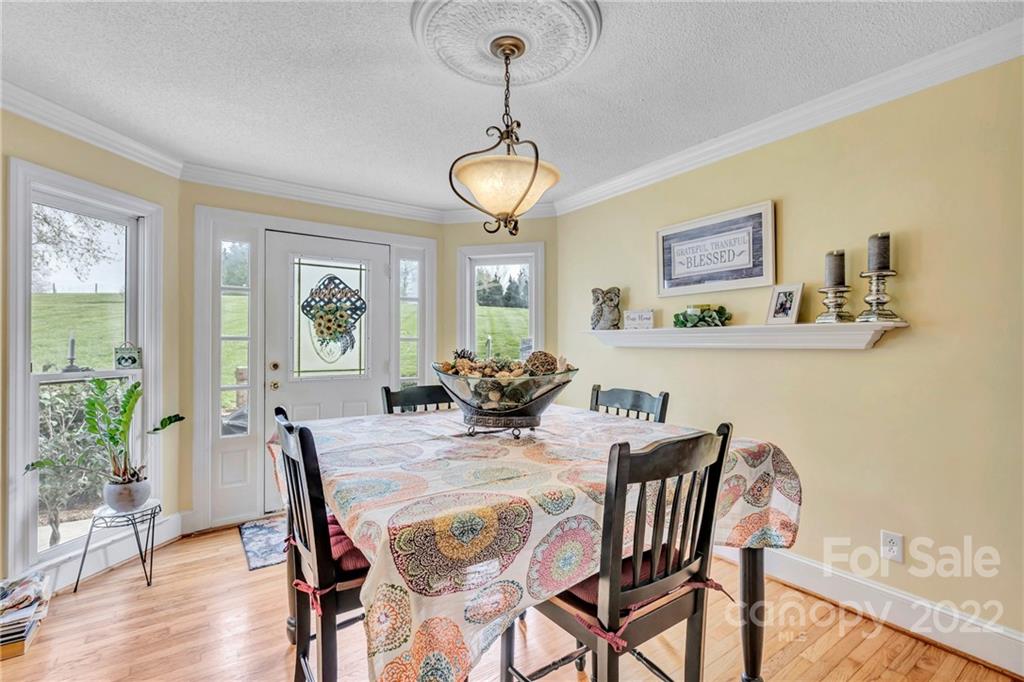 331 Polk Ford Road Stanfield, NC 28163 - Photo 26 of 47 a view of a dining room with furniture window and wooden floor
