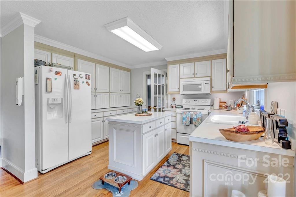 331 Polk Ford Road Stanfield, NC 28163 - Photo 27 of 47 a kitchen with stainless steel appliances a stove refrigerator sink and cabinets