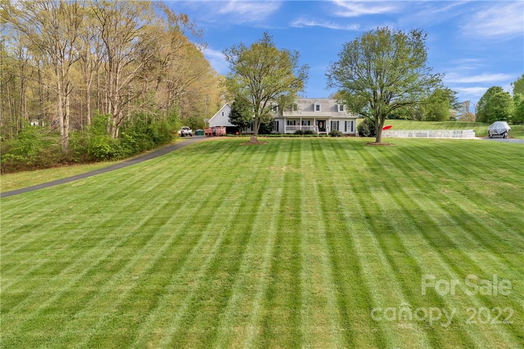 331 Polk Ford Road Stanfield, NC 28163 - Photo 3 of 47 a view of yard with swimming pool and green space