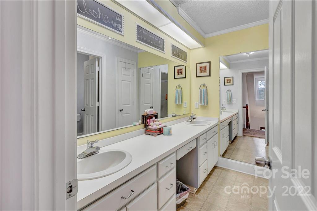 331 Polk Ford Road Stanfield, NC 28163 - Photo 37 of 47 a bathroom with a sink double vanity granite and a mirror