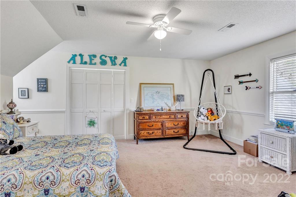 331 Polk Ford Road Stanfield, NC 28163 - Photo 38 of 47 a bedroom that has a bed and a chandelier