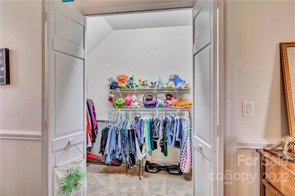 331 Polk Ford Road Stanfield, NC 28163 - Photo 41 of 47 a view of walk in closet with clothes