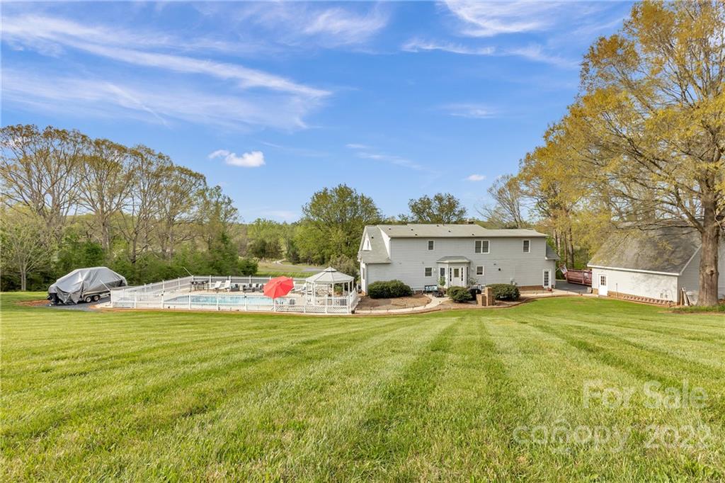 331 Polk Ford Road Stanfield, NC 28163 - Photo 7 of 47 a view of a house with swimming pool and yard