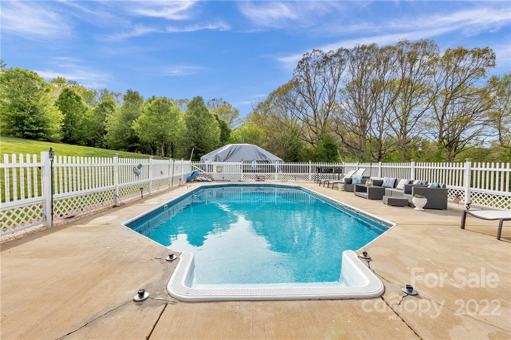 331 Polk Ford Road Stanfield, NC 28163 - Photo 8 of 47 a view of a swimming pool with a patio and a yard