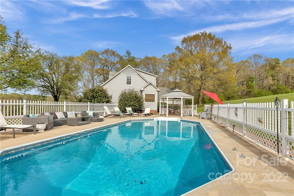 331 Polk Ford Road Stanfield, NC 28163 - Photo 9 of 47 a view of a house with pool and a yard