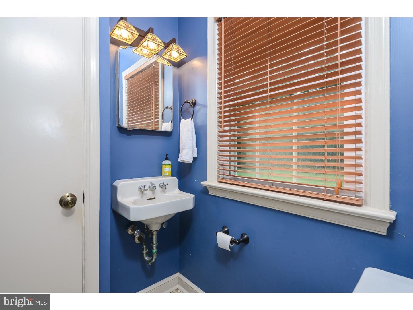 105 Beatty Road Media, PA 19063 - Photo 14 of 25 a bathroom with a sink a mirror and a window