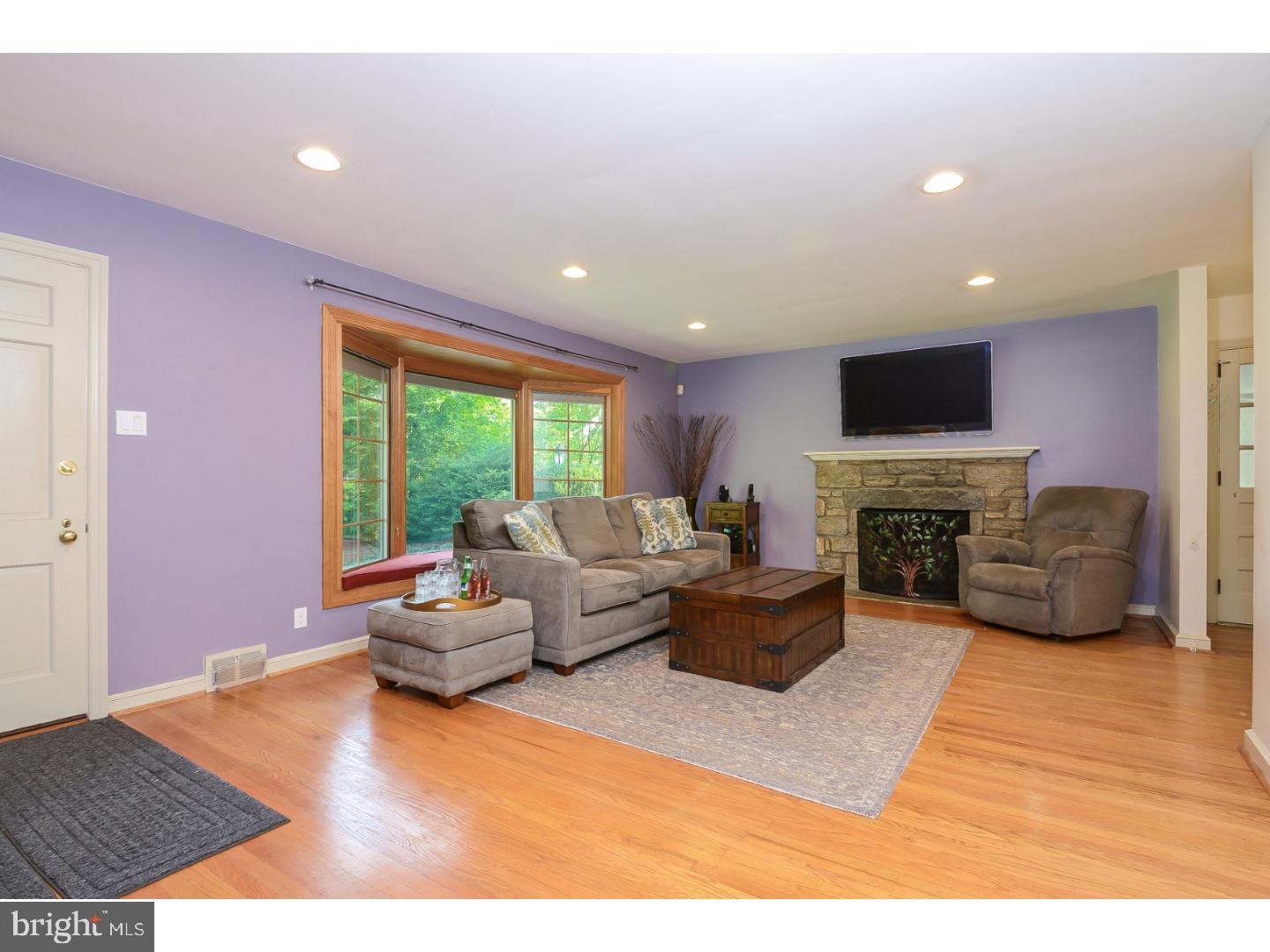 105 Beatty Road Media, PA 19063 - Photo 4 of 25 a living room with furniture flat screen tv and a fireplace