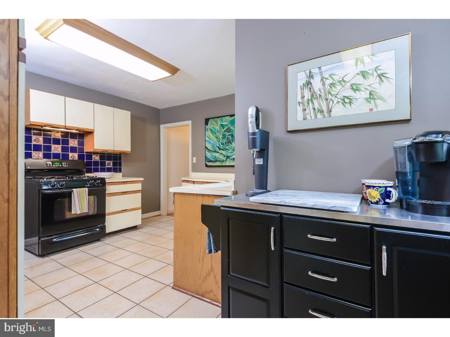 105 Beatty Road Media, PA 19063 - Photo 6 of 25 a kitchen with stainless steel appliances a stove a sink and a microwave