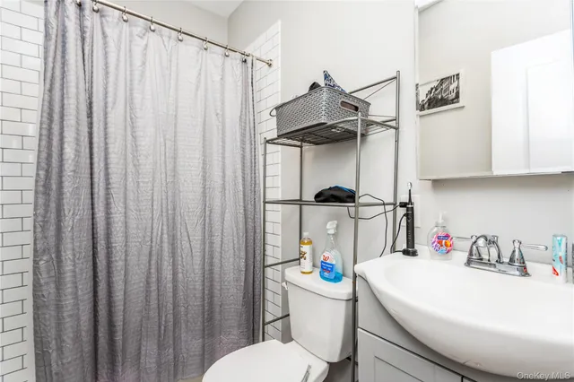 a white toilet sitting next to a bathroom sink