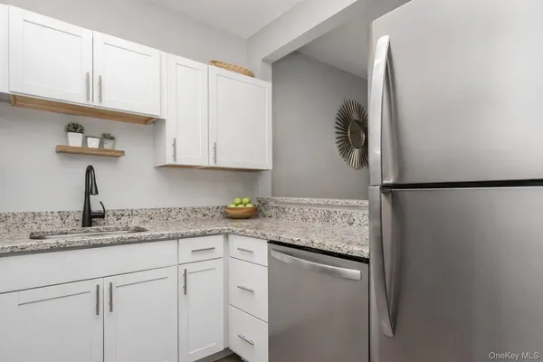 a kitchen with a sink dishwasher and cabinets