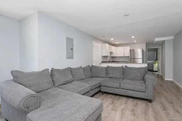 a living room with furniture and kitchen view