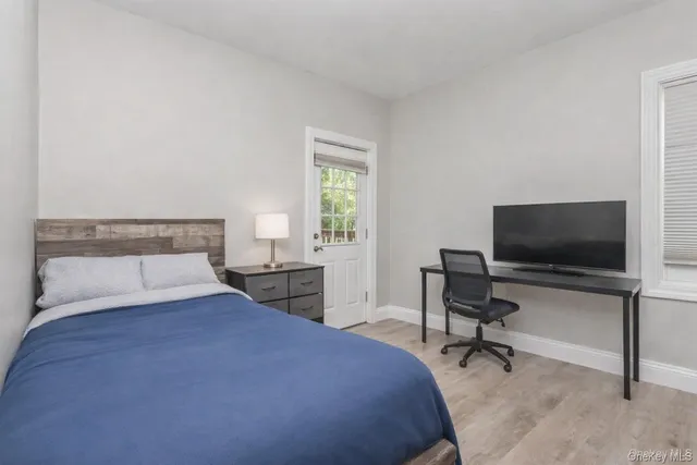 a bedroom with a bed and a flat screen tv