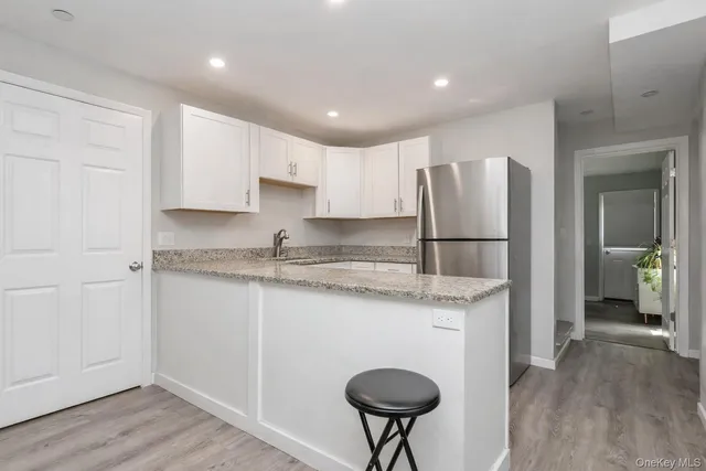 a kitchen with stainless steel appliances granite countertop a refrigerator a sink and a stove