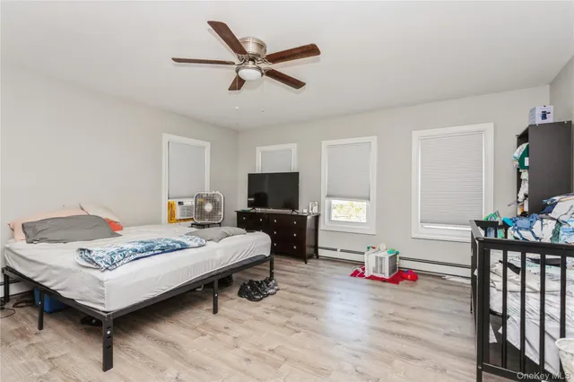 a bedroom with furniture and a wooden floor