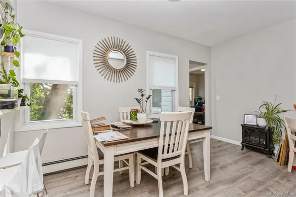 a view of a dining room with furniture and a large window