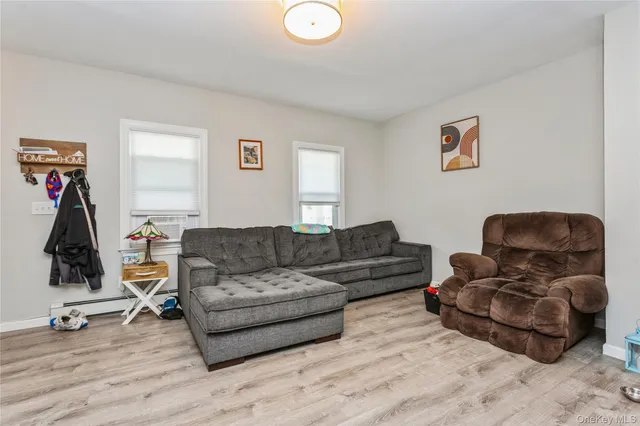 a living room with furniture gym equipment and a wooden floor