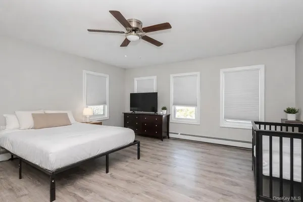 a bedroom with a bed a couch and window