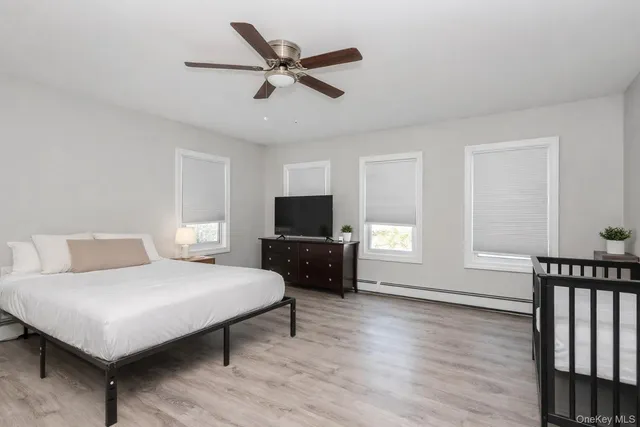 a bedroom with a bed a couch and window