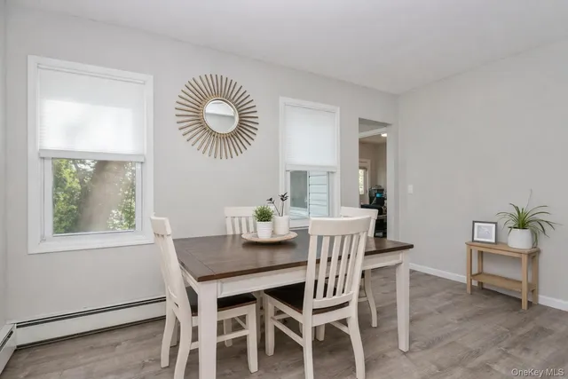 a view of a dining room with furniture and chandelier