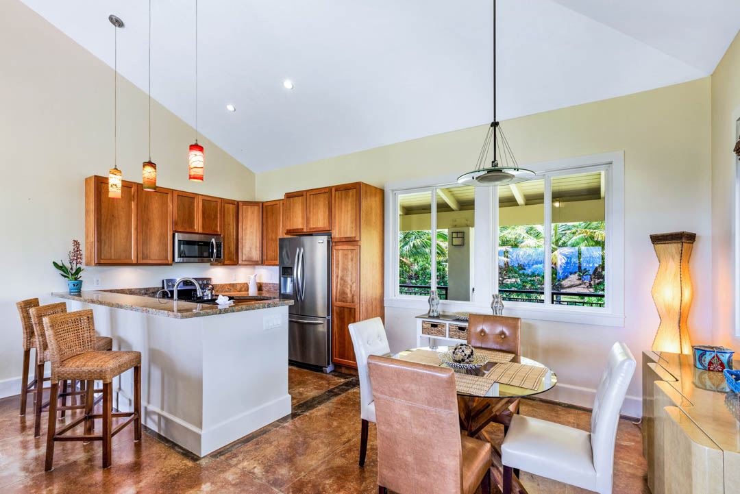 405 East Kuiaha Road Haiku, HI 96708 - Photo 8 of 30 a kitchen with stainless steel appliances a table chairs refrigerator and microwave
