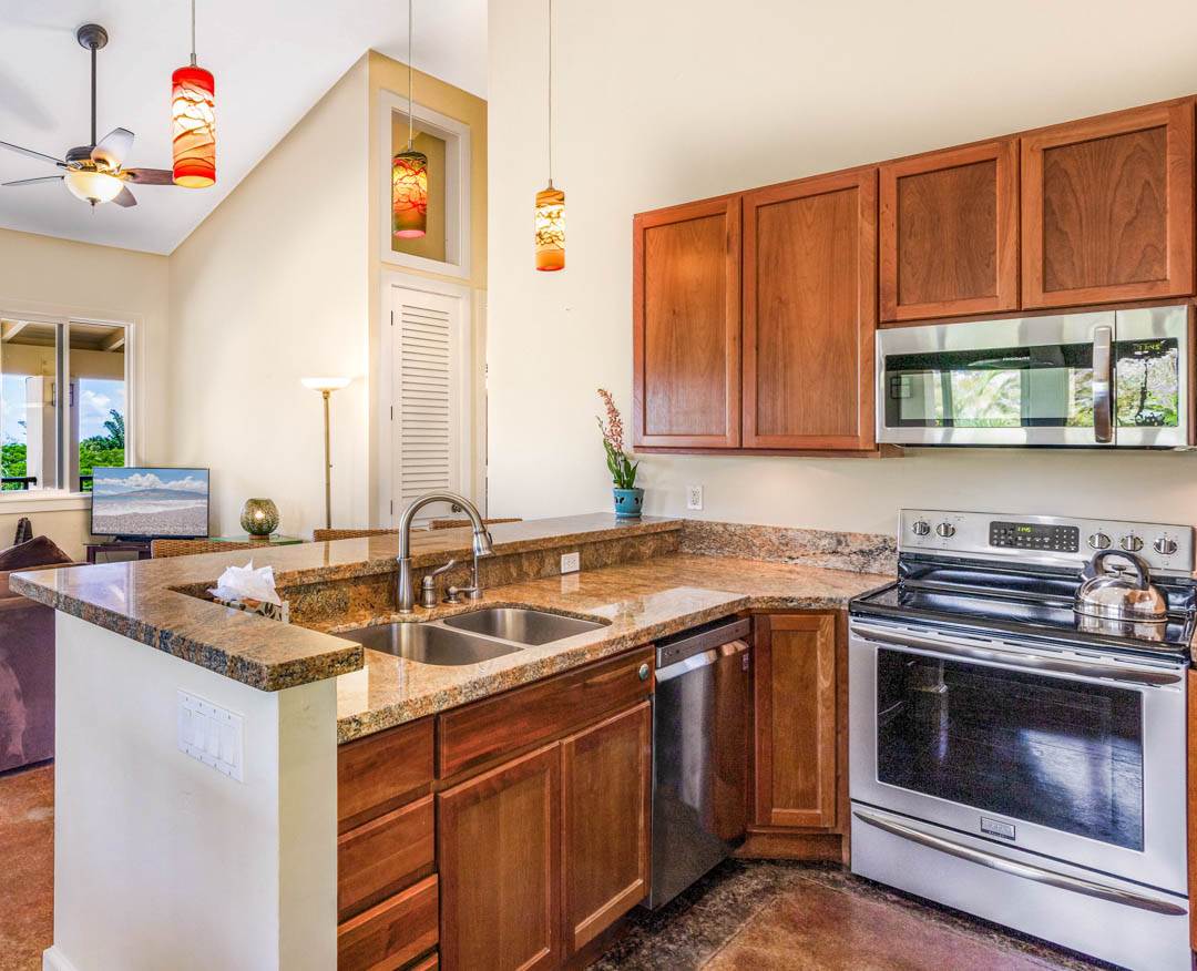 405 East Kuiaha Road Haiku, HI 96708 - Photo 10 of 30 a kitchen with stainless steel appliances granite countertop a sink stove and cabinets