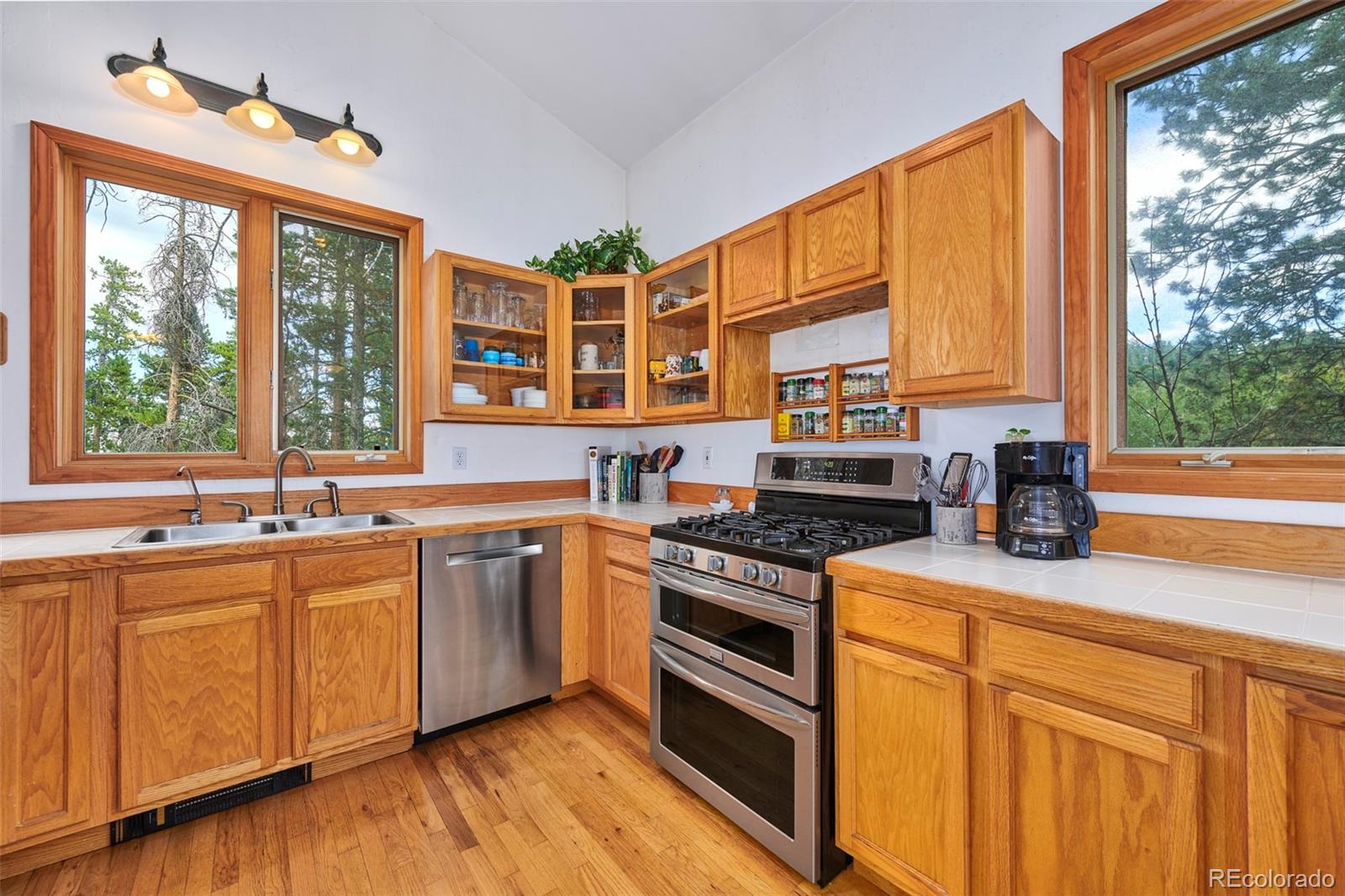 11838 Ridge Road Golden, CO 80403 - Photo 8 of 35 a kitchen with stainless steel appliances granite countertop a stove a sink and a microwave