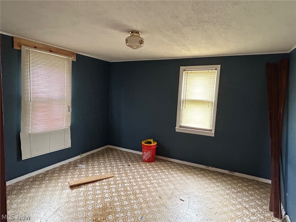 4106 Jaeger Road Lorain, OH 44053 - Photo 4 of 17 Tiled spare room featuring a textured ceiling