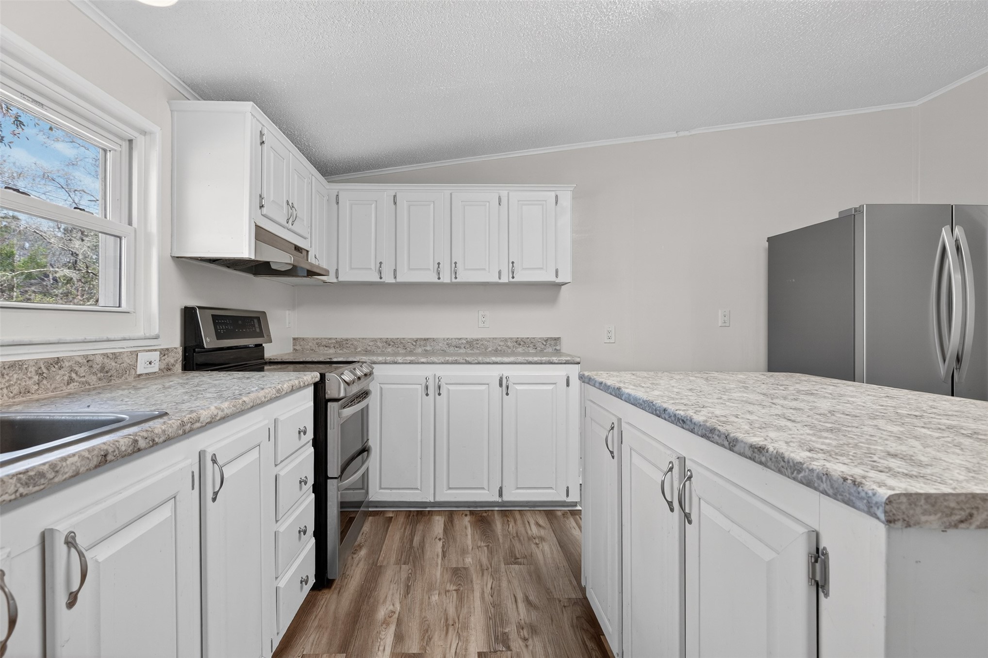 95021 Raintree Lane Fernandina Beach, FL 32034 - Photo 10 of 36 a kitchen with granite countertop cabinets stainless steel appliances a sink and wooden floor