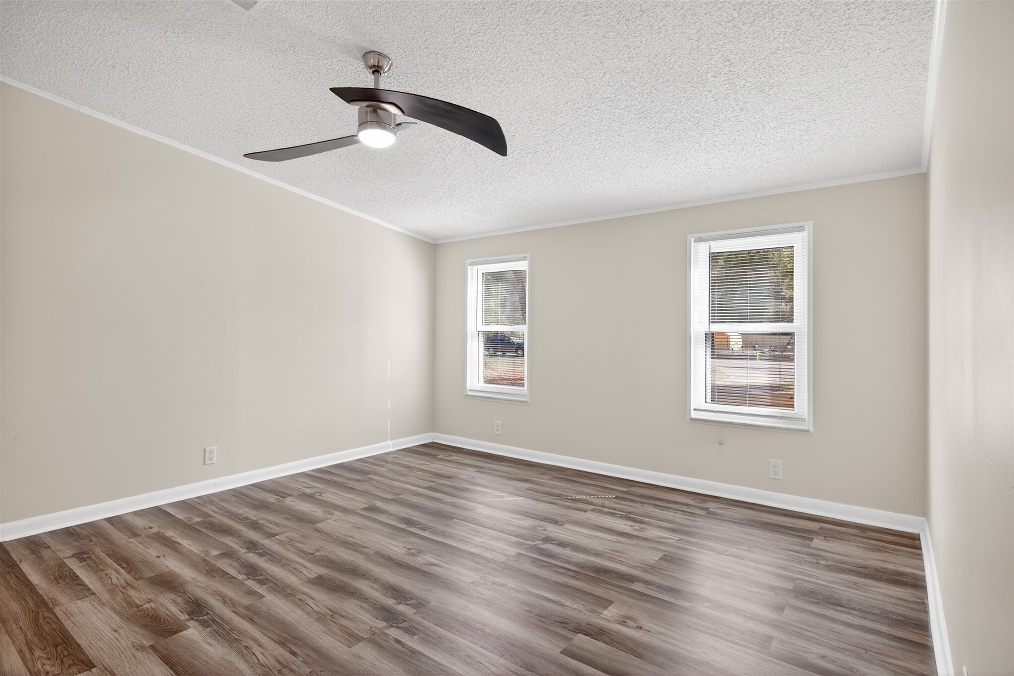 95021 Raintree Lane Fernandina Beach, FL 32034 - Photo 17 of 36 a view of an empty room with wooden floor and a window