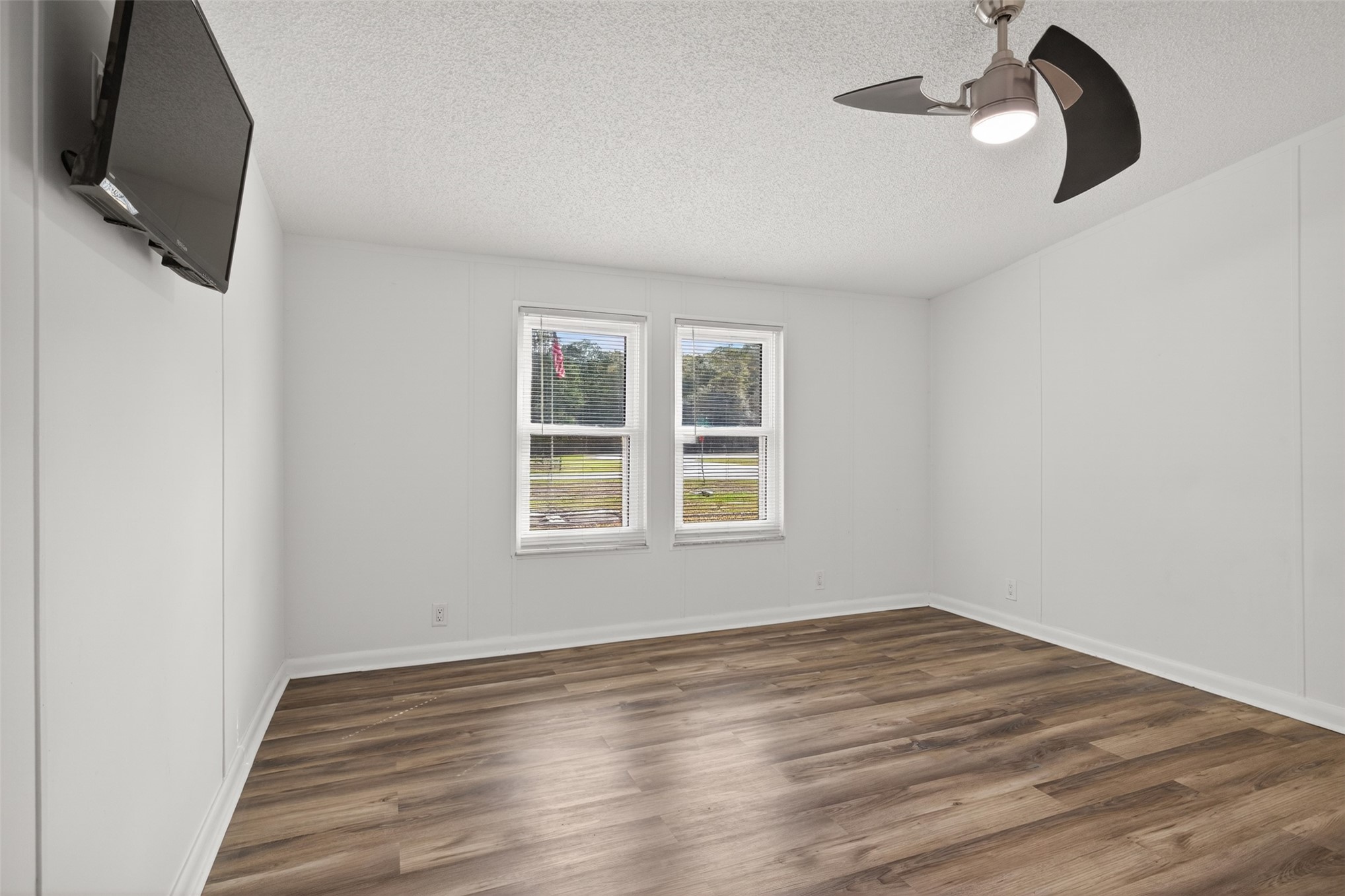 95021 Raintree Lane Fernandina Beach, FL 32034 - Photo 25 of 36 an empty room with wooden floor cabinet and windows