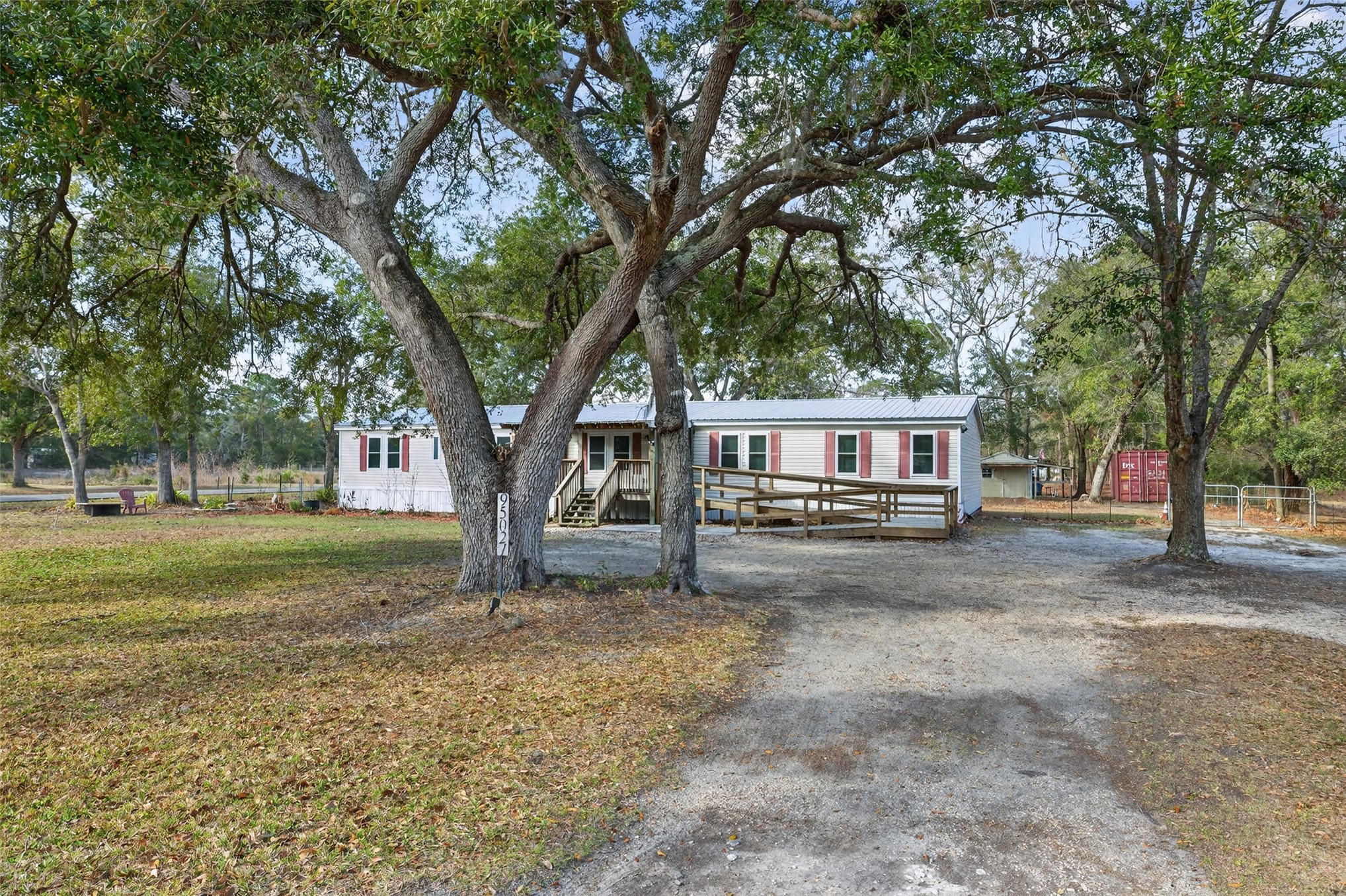 95021 Raintree Lane Fernandina Beach, FL 32034 - Photo 34 of 36 a view of a yard with a house and large trees