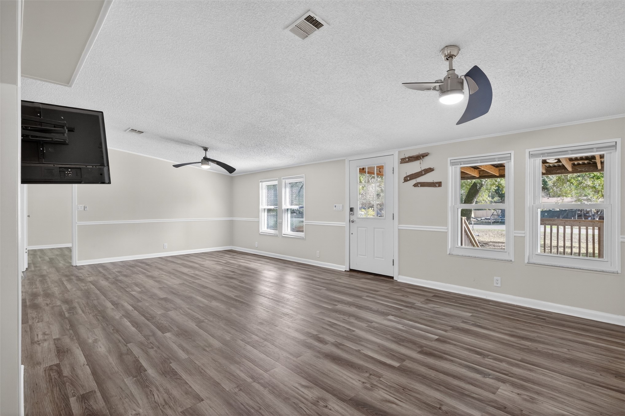 95021 Raintree Lane Fernandina Beach, FL 32034 - Photo 7 of 36 a view of empty room with wooden floor and fan