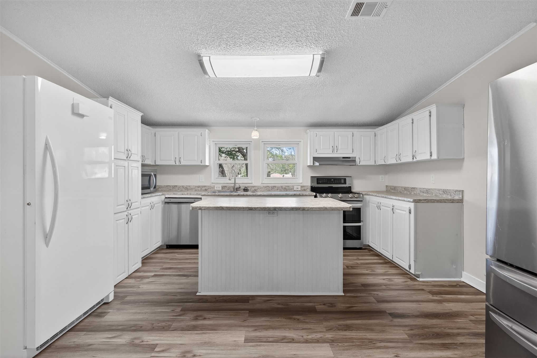 95021 Raintree Lane Fernandina Beach, FL 32034 - Photo 8 of 36 a kitchen with a refrigerator a sink and cabinets