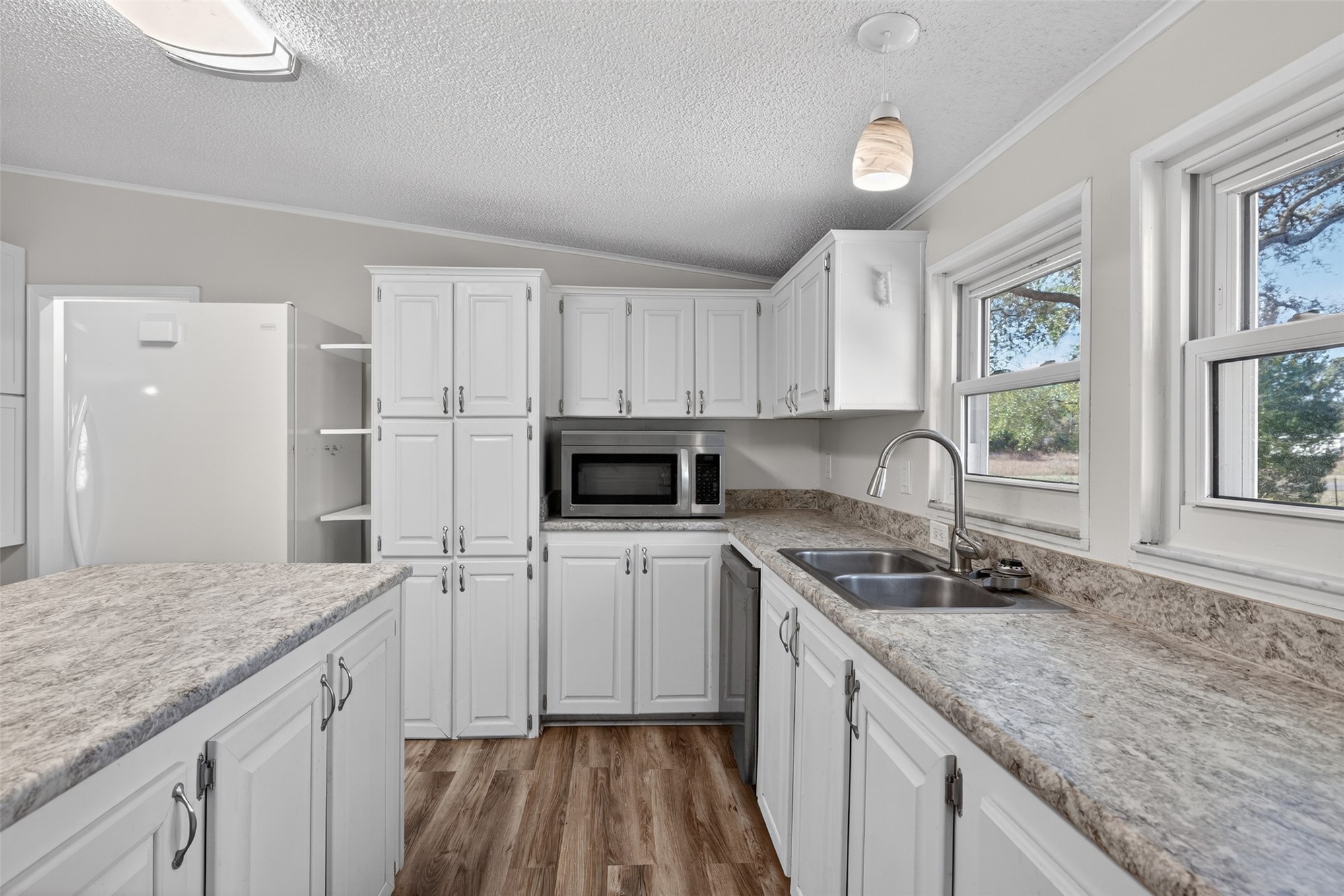 95021 Raintree Lane Fernandina Beach, FL 32034 - Photo 9 of 36 a kitchen with a sink stove and cabinets