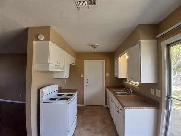 a kitchen with a stove and a refrigerator
