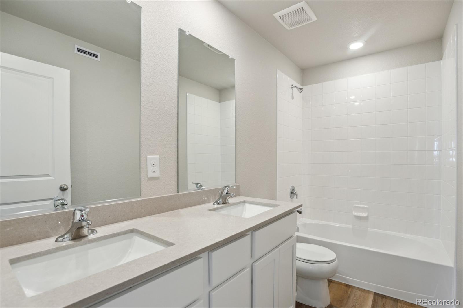 7416 Poudre Street Frederick, CO 80530 - Photo 16 of 30 a bathroom with a granite countertop sink a toilet and a bathtub