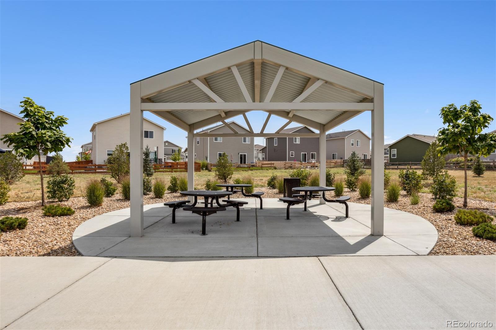 7416 Poudre Street Frederick, CO 80530 - Photo 25 of 30 a view of a patio with a table and chairs under an umbrella