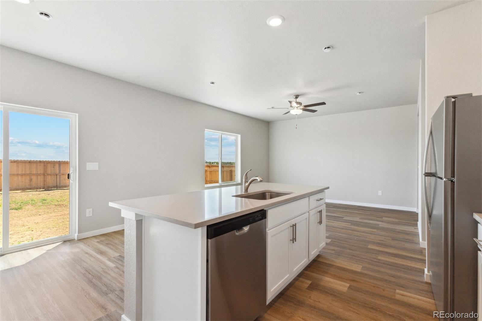 7416 Poudre Street Frederick, CO 80530 - Photo 5 of 30 a view of a kitchen counter space a sink and wooden floor