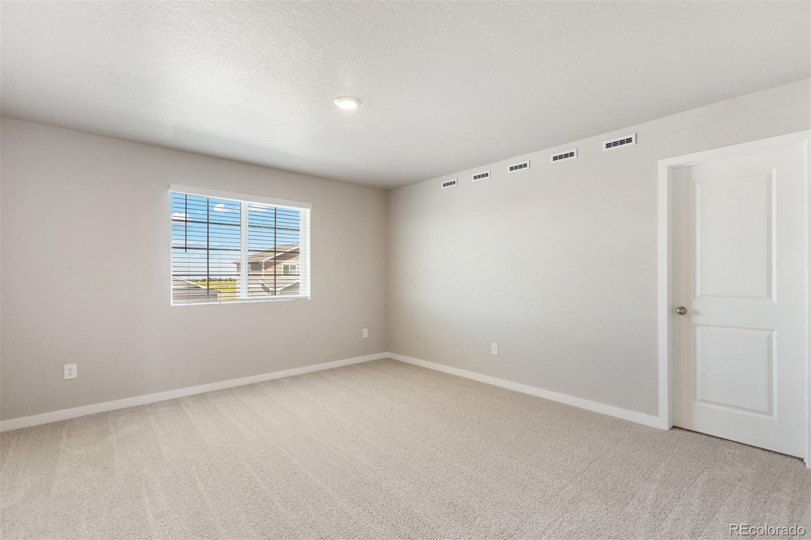 7416 Poudre Street Frederick, CO 80530 - Photo 9 of 30 a view of an empty room with a window