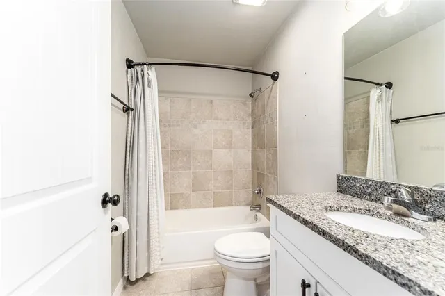 an empty room with closet and a chandelier fan