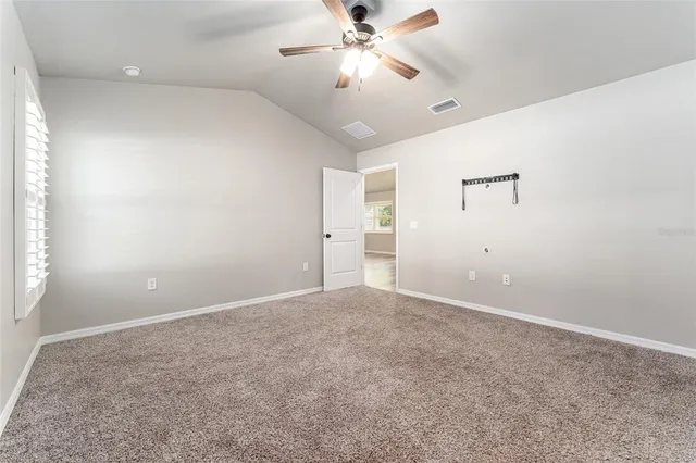 a bathroom with a granite countertop sink a toilet and shower