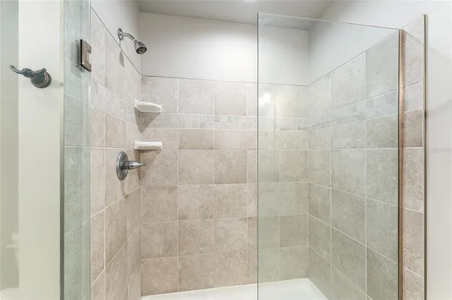 a view of a bedroom with wooden floor and window