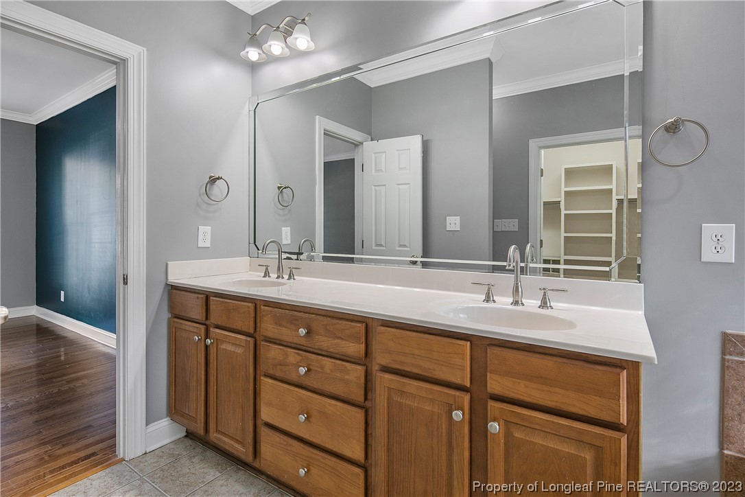 115 Blue Pine Drive Spring Lake, NC 28390 - Photo 21 of 48 a bathroom with double vanity sinks and a mirror
