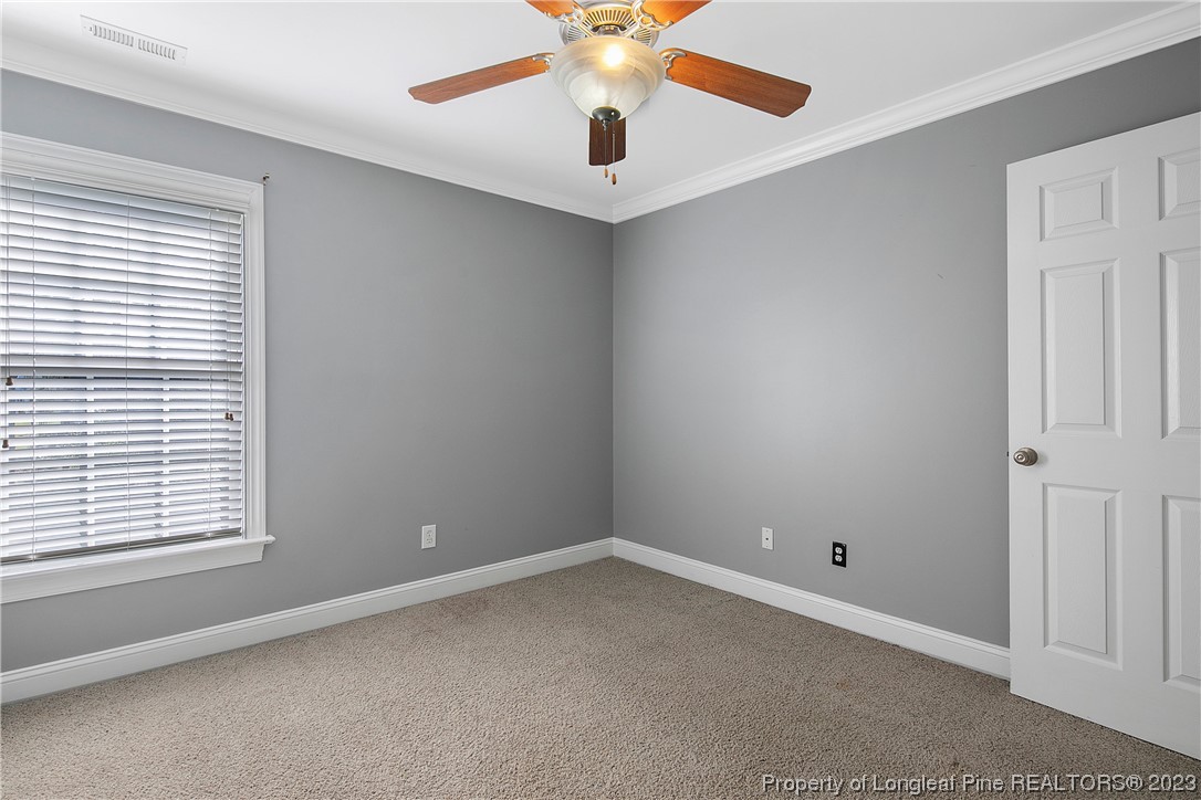 115 Blue Pine Drive Spring Lake, NC 28390 - Photo 27 of 48 an empty room with windows and fan